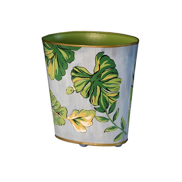 New special order item. Not vintage. Hand painted oval wastebasket with tropical leaf design over light blue background,...