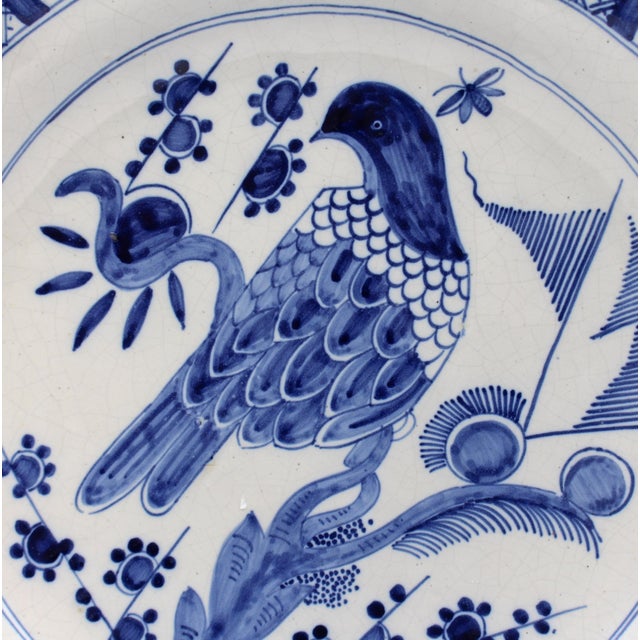 Early 20th century Delft blue & white Bird Charger, Dutch. Large central bird motif with diapered panels alternating with...