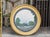 A striking oversized English convex mirror from the 19th century, featuring a beautifully balanced combination of giltwood...
