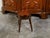 An English mahogany tray top side table from the 19th century, with splaying legs and casters. Created in England during...