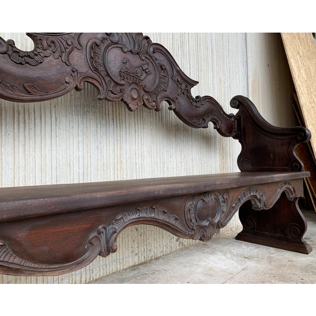 19th century French bench made from oak. The back is exquisitely hand carved with two differents motifs, surrounded by...