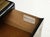 This striking three-drawer commode is a premier example of 1970s Hollywood Regency and Brutalist design, showcasing the...