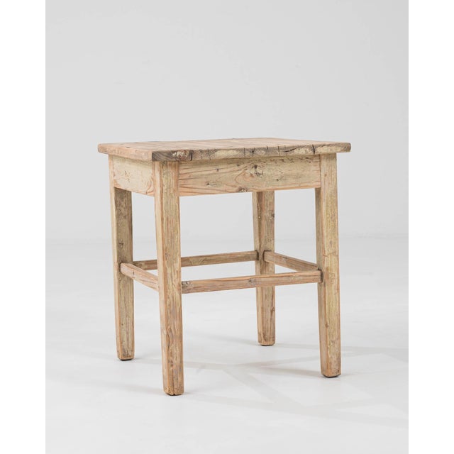 This Early 20th Century Central European wood patinated stool is a testament to the timeless beauty and durability of...