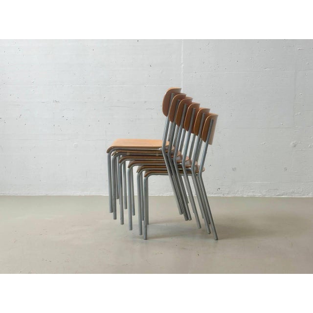 A functional vintage stacking chair with a clean, minimalist design, likely from the 1970s. The combination of warm...