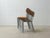 A functional vintage stacking chair with a clean, minimalist design, likely from the 1970s. The combination of warm...