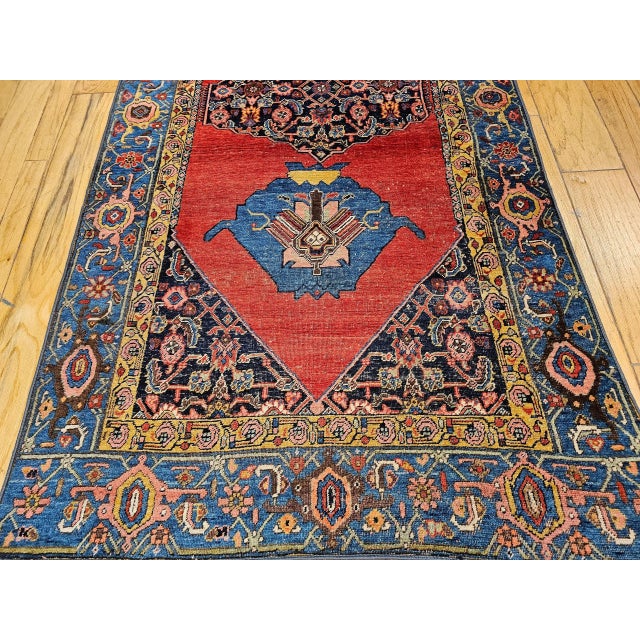 4’ 5” x 9’ 3” Late 19th century Persian Bidjar in a medallion geometric pattern. The rug has an open field design set on a...