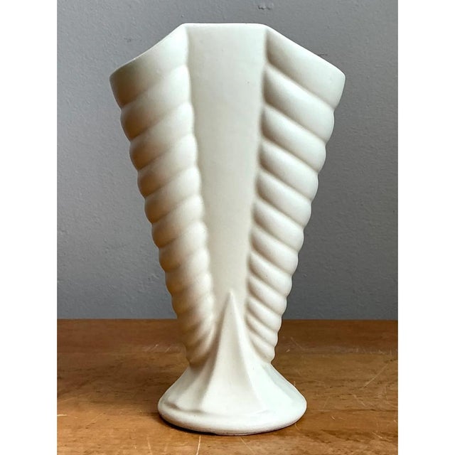 This vase makes a confident architectural statement through its fan-shaped silhouette and deeply articulated ribbed...