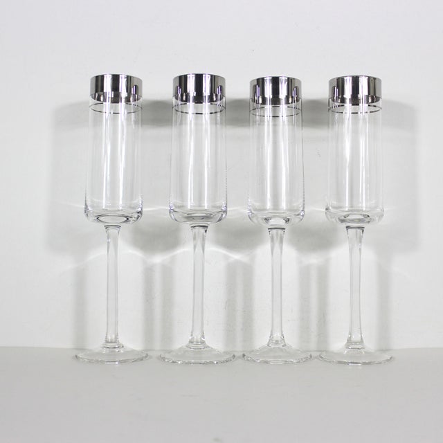 Very tall mid century modern champagne flutes with a wide and narrow silver band at the rim. Set of four. In excellent...