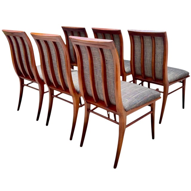 Exceptional set of six vintage Mid-Century Modern dining chairs featuring beautifully sculptural solid walnut frames with...