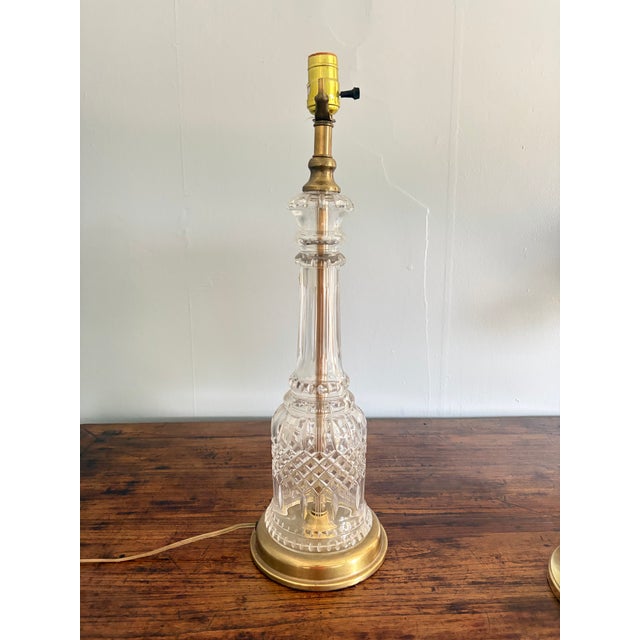 Elegant vintage Hollywood Regency table lamp featuring a tall, urn-form cut-glass body with intricate fluted and faceted...