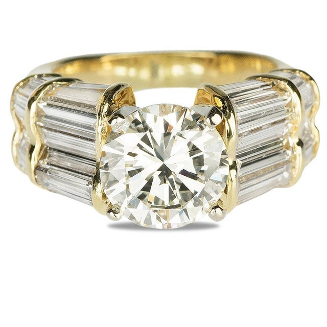 18k Ring with GIA certified (5191980106) M color VVS1, 2.62 carat round brilliant and 36 baguette diamonds weghing...