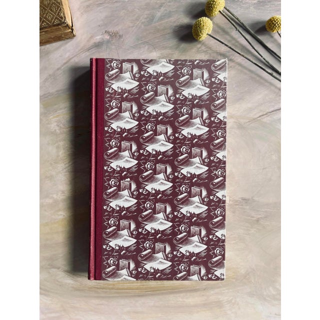 lovely edition of poems by shakespeare, printed in england in 1958. the cover depicts paper and books, with a rose in...