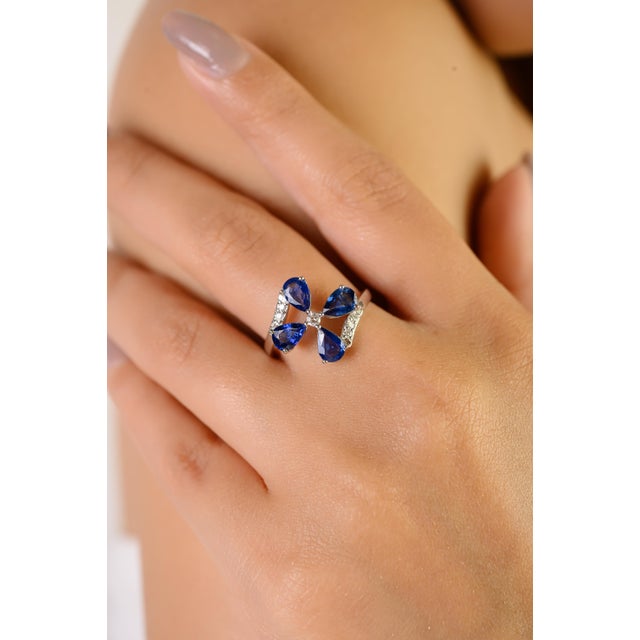 This elegant ring features 4 pear-cut blue sapphire totaling 1.58 carats, set in 14K white gold. Each gemstone measures...