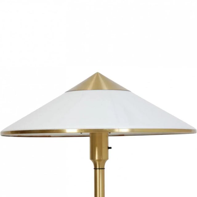 Fog and Mørup Royal light table lamp with a brass frame and a plastic shade. The lamp is from around the 1990s and appears...