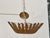 An Italian carved giltwood sunburst chandelier from the early 20th century, circa 1920–1930, featuring a rich finish and...