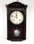 A vintage Ryusuisha wall clock featuring a dark polish wood mahogany - colored clock case. The clock features a scalloped...