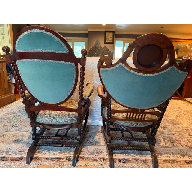 A beautiful matched pair of antique Franklin Victorian rocking chairs featuring classic barley twist turnings, scroll...