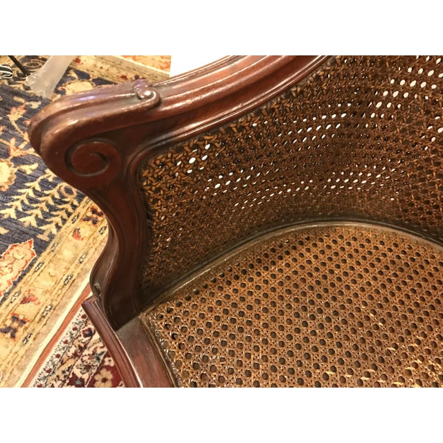 This elegant antique French caned barrel chair has been in my family for over 70 years and was originally part of my...