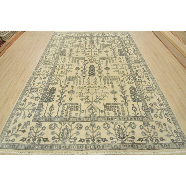 This traditional Oushak rug is hand-knotted with an all-wool pile on a cotton foundation. This rug is new and in excellent...