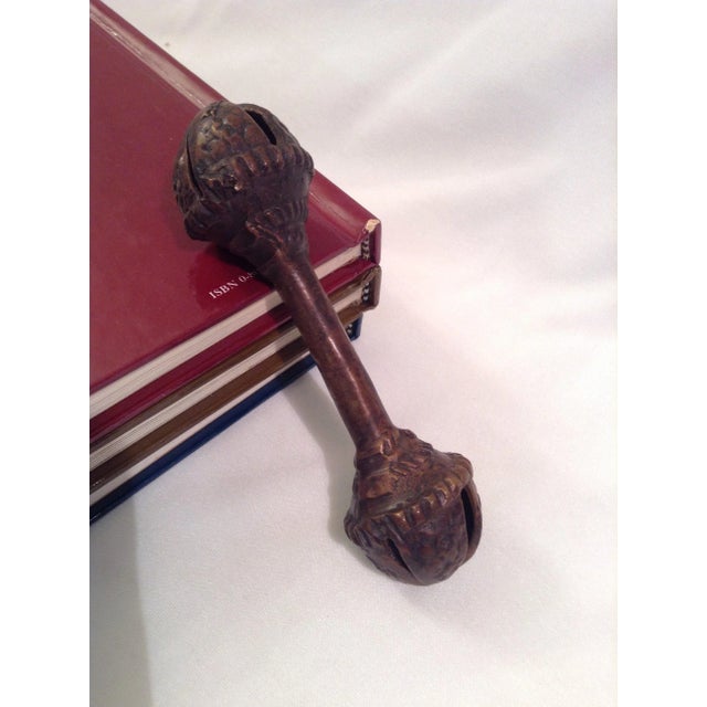 Rare vintage brass bell rattle plays the sounds of sleigh bells or Christmas bells when shaken. Handbell in the shape of a...