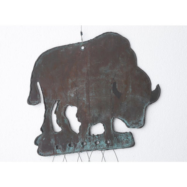 Very unique vintage bronze bison wind chime. There ais some added art done in black marker but I'm not sure if it's from...
