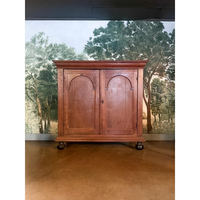 This 18th Century Dutch Arched Panel Cabinet is a beautifully substantial piece with timeless European character. Crafted...