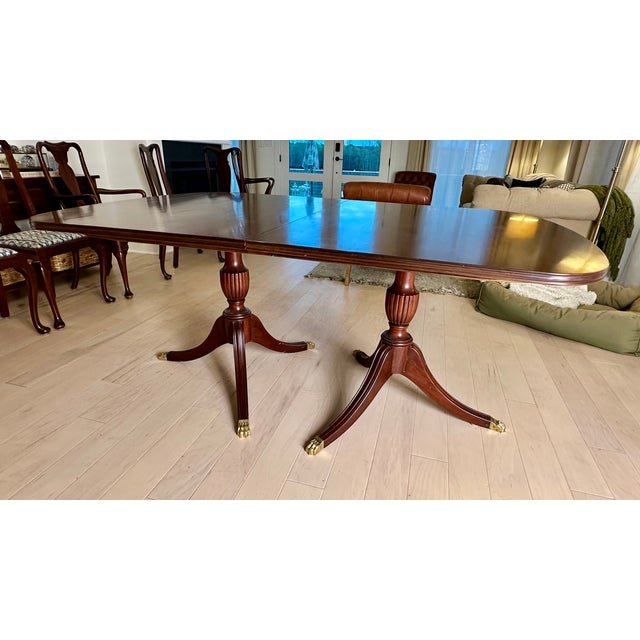 High Quality American Made Expandable Mahogany Dining Table On Double Pedestal Base with Brass Capped Feet, Includes Four...