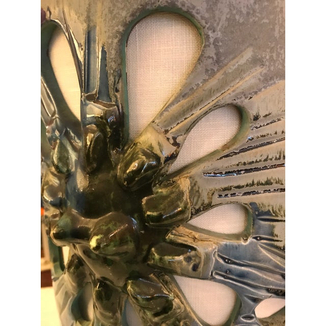 This is an amazing 1960's cylindrical openwork ceramic table lamp. The cut outs are the flower petals and the center of...