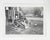 Early 20th century snapshot photograph of a hardworking mom soaking her feet. Seated at the bottom the stairs of a rough...