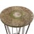 This round accent table features a rustic and patinaed stone top with an open-wire, tapered metal rod base. The airy...