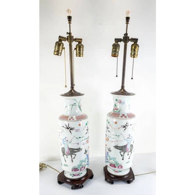 We are selling this fabulous pair of Chinese famille rose rouleau vases mounted as lamps. These lamps have soft enamel...