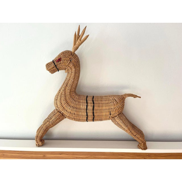 Large three dimensional 1970s wicker reindeer handmade in Hong Kong featuring black striped accents, red eyes, uplifted...