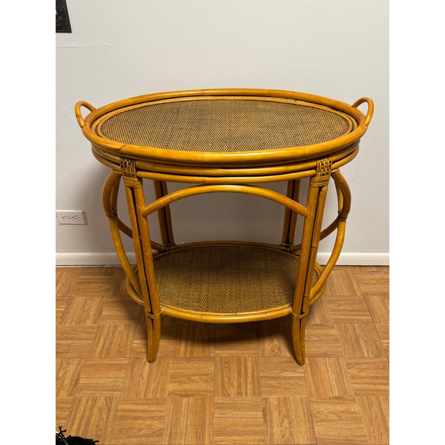 A beautifully crafted vintage rattan and bamboo two-tier oval serving table, circa 1960s–1980s, offering that perfect...