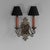 Twin arm wall sconce with original faux candles in original paint finish. Shades not included. Circa 1920. Up to 250V...