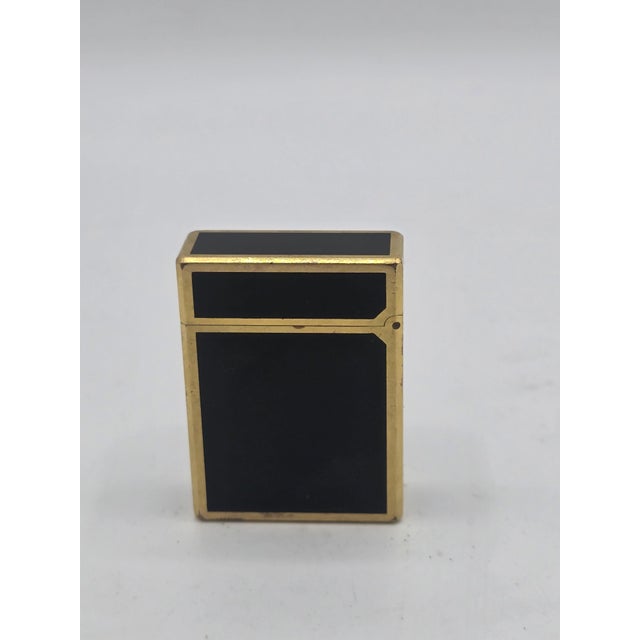 S.T. Dupont Line 1 lighter, dating from approximately the 1970s-1980s, made in France. Gold finish and black Chinese...