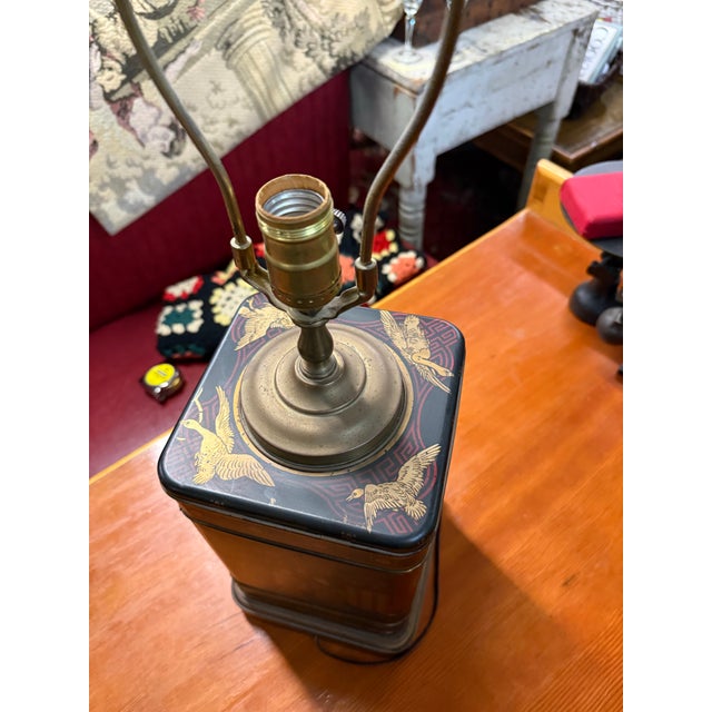 Beautiful matching pair of vintage chinoiserie-style table lamps featuring detailed Asian-inspired figural scenes in rich...