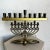 This elegant vintage menorah lamp features a classic brass design with ornate scrollwork and floral detailing. Combining...