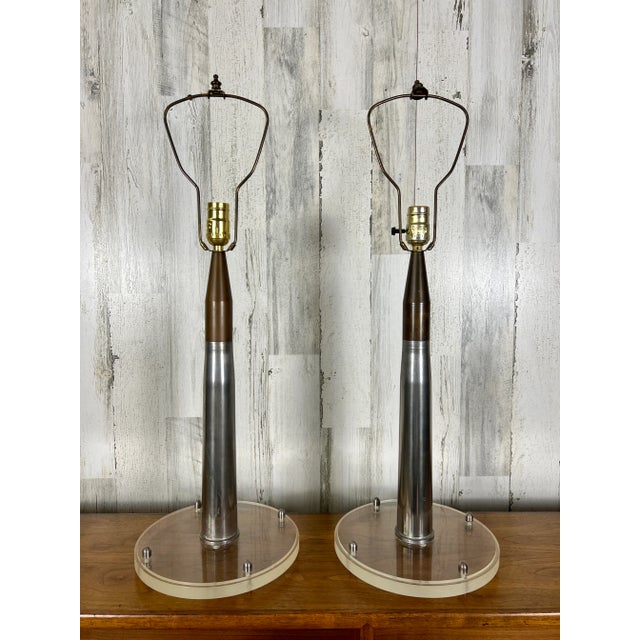 Assembled in the 1980’s these shells have a nice patina With lucite circular bases and new shades Measurement is to the...