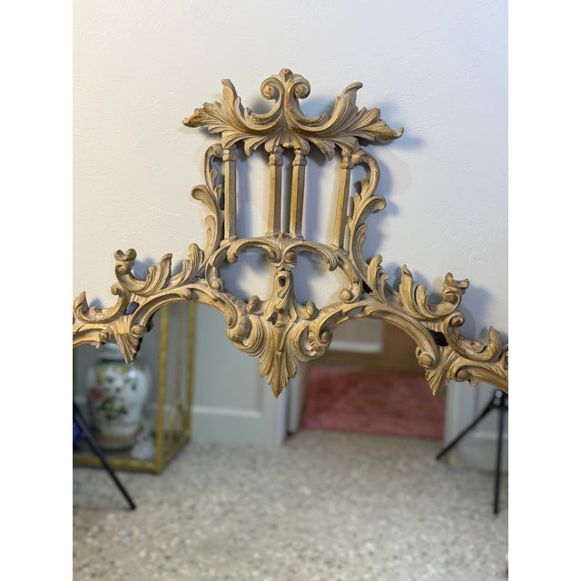 This ornate piece can best be described as a Chinoiserie mirror from the Chippendale period. It exhibits Rococo style. It...