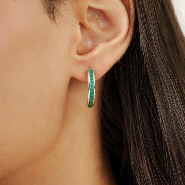 Featuring square-cut green onyx gemstones measuring 2.5 mm and weighing 1.9 carats, these half hoop earrings are crafted...
