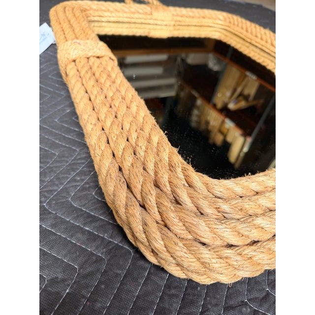 Coastal bohemian mirror featuring a warm woven jute rope frame with softly rounded corners and layered detailing. A...