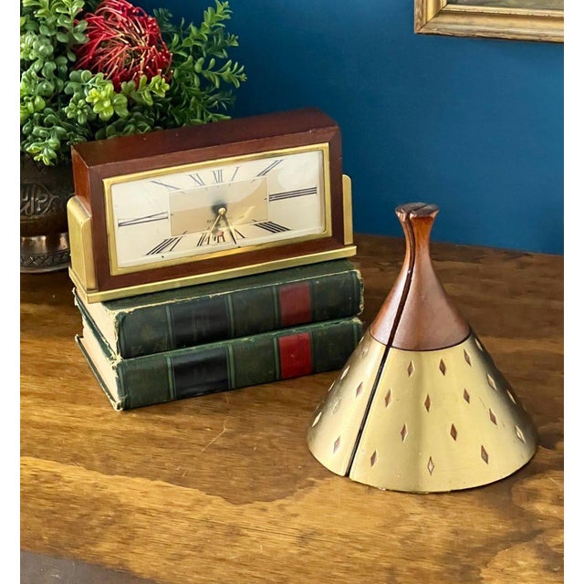 A striking mid-century modern desk set featuring a vintage Seth Thomas Clock Company electric clock paired with a...