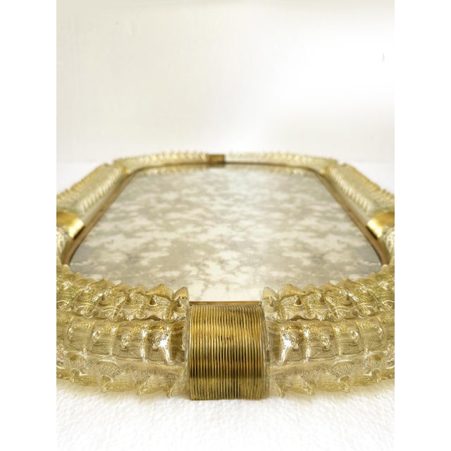 Impressive scenographic wall mirror in unlaquered brass elements with trasparent ando gold leaf inside working in...