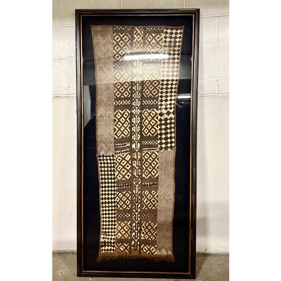 Gorgeous framed vintage African Kuba cloth textile showcased in a large rich black distressed glass frame with matte....