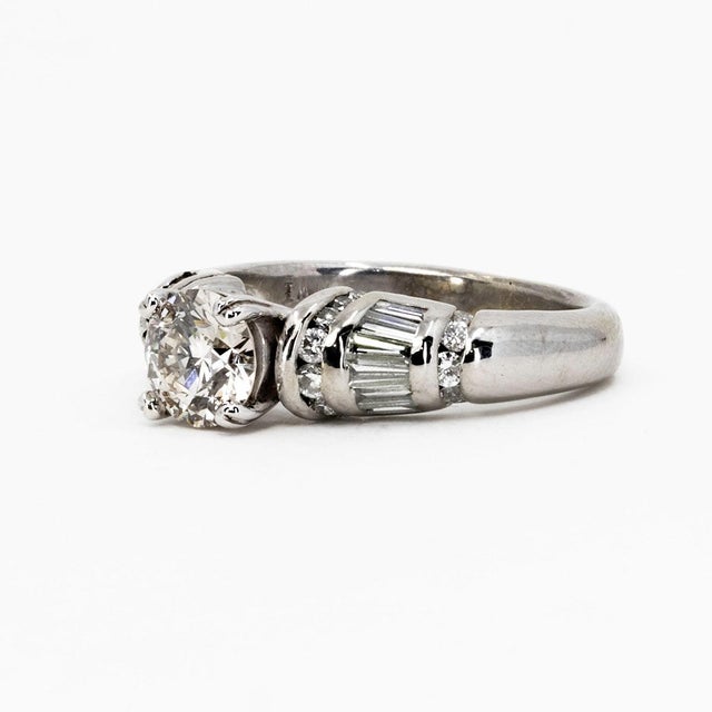 14k White gold ring with GIA certified 1.04 carat L color VS1 clarity round and 12 baguette diamonds weighing...