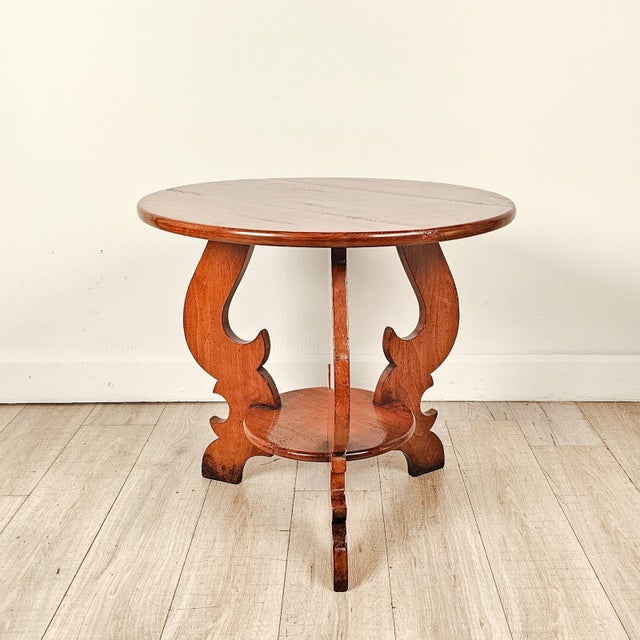 A bespoke cherry vintage round table, made in the Italian style, with antiqued finish.