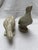 A pair of antique cast stone or cement life size statues of doves or pigeons.