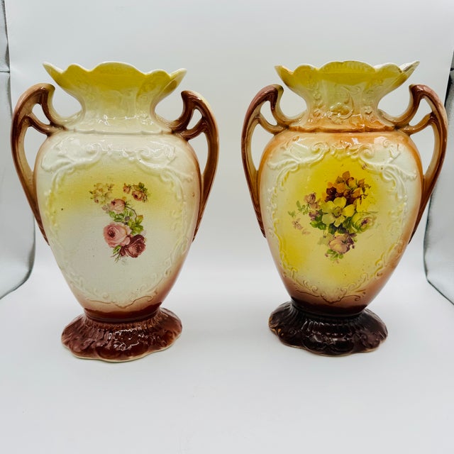 These vases are believed to be antique English Strasburg Ware ceramic porcelain urns, featuring high-gloss finishes and...
