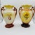 These vases are believed to be antique English Strasburg Ware ceramic porcelain urns, featuring high-gloss finishes and...