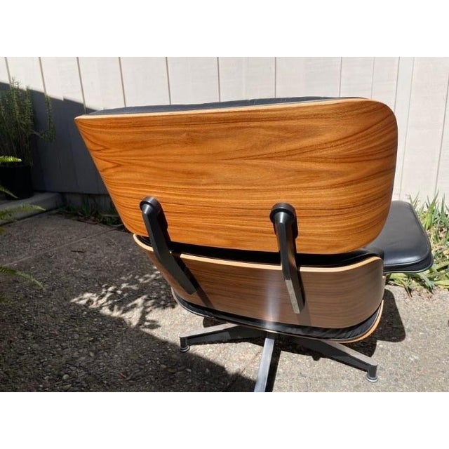 This 2014 authentic Herman Miller Eames Lounge Chair and Ottoman in Walnut and Black Leather is a luxurious and stylish...